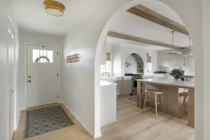 Entryway and arched doorway into kitchen