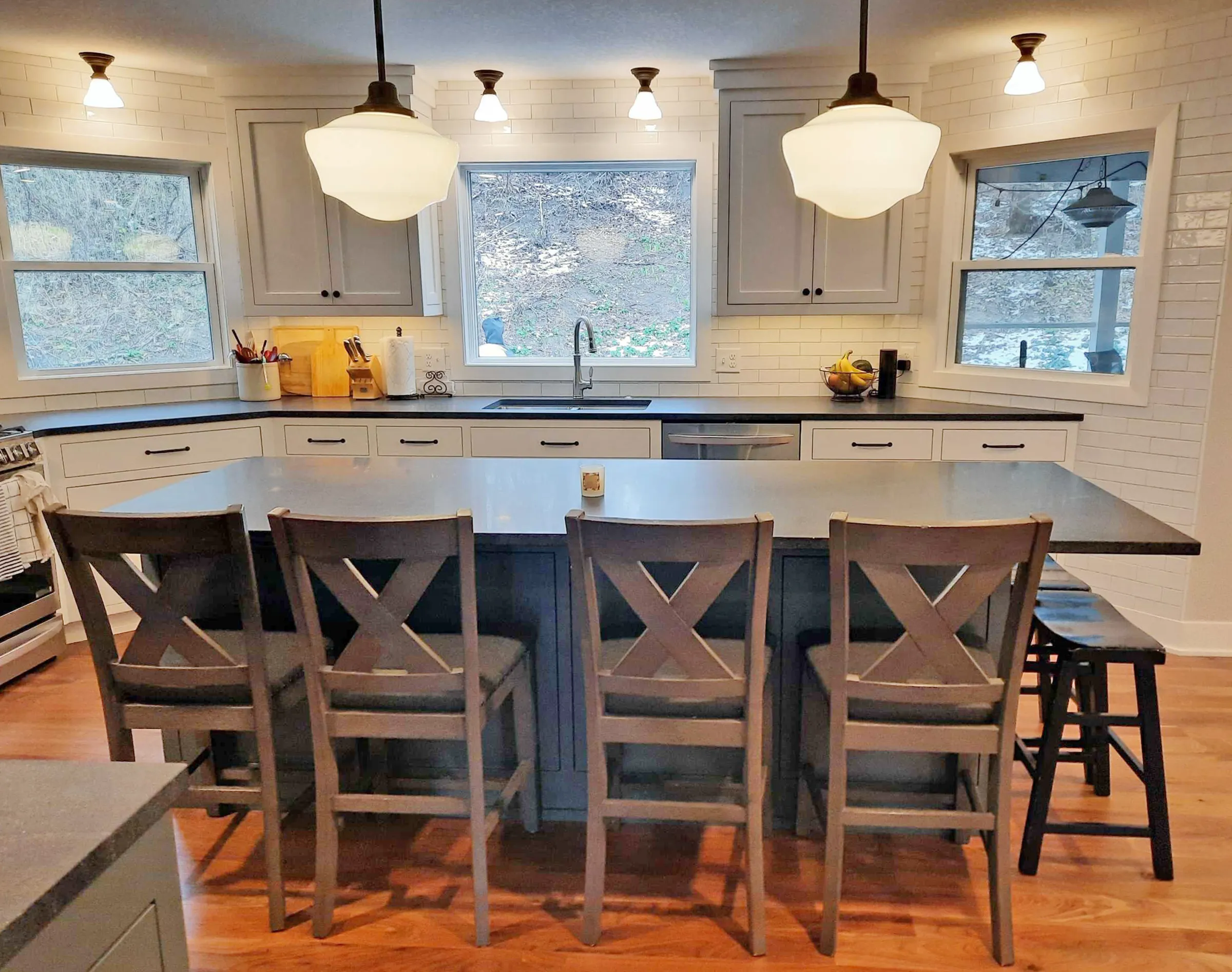 Remodeled kitchen with large island, large windows and pendant lighting