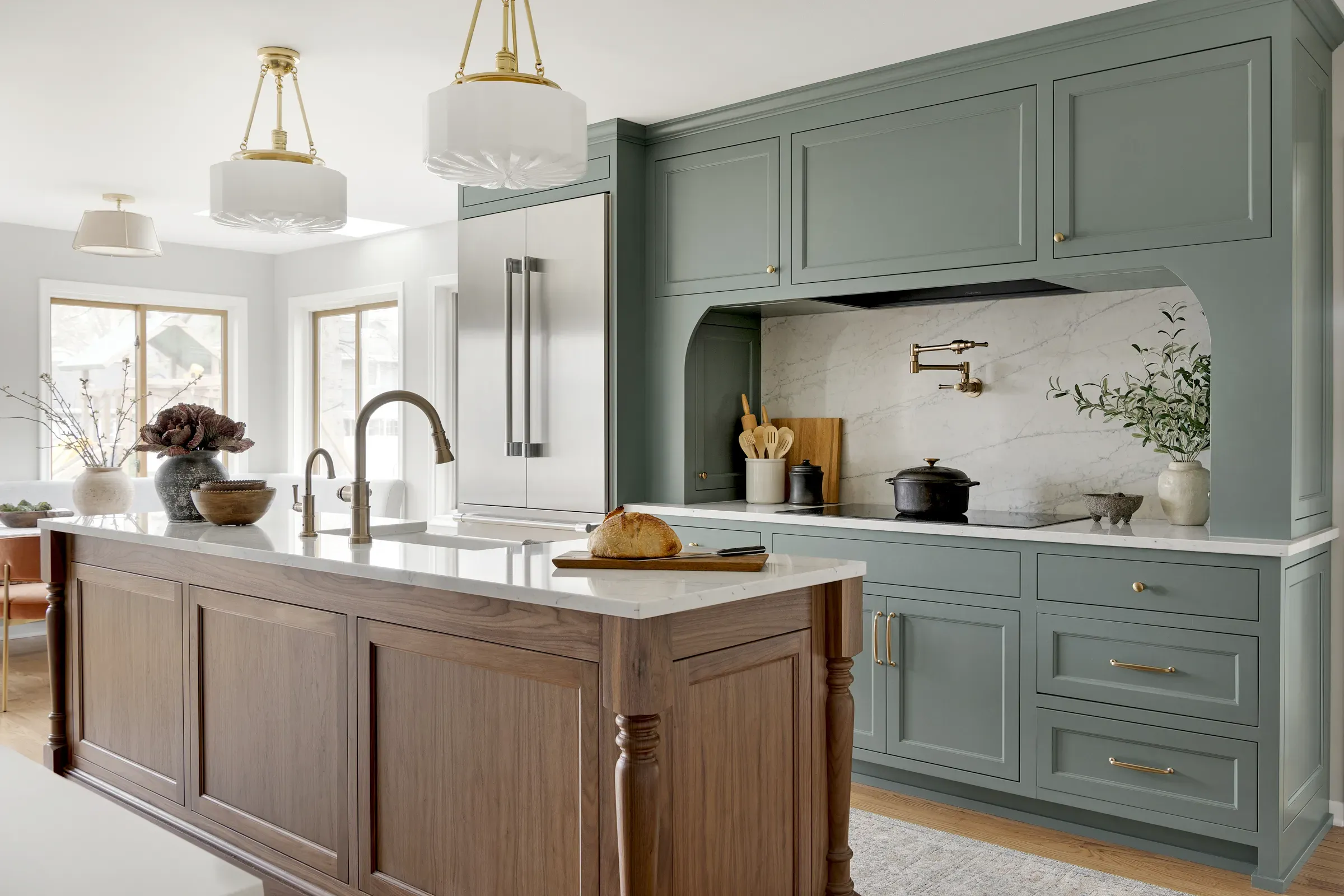 kitchen with green cabinetry and dark wood island